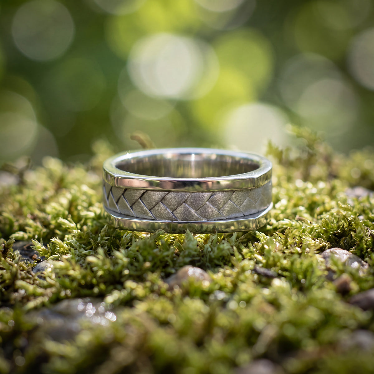 White gold band with a woven center and wide polished edges