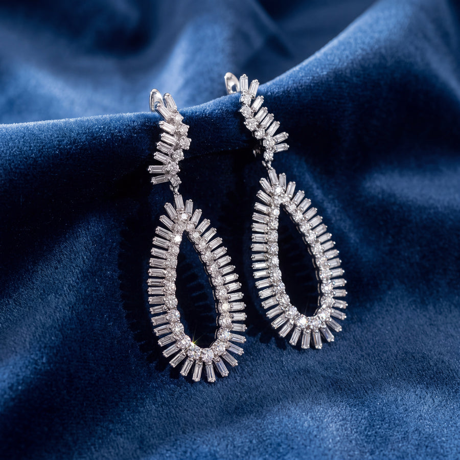 Open teardrop drop earrings with a fringe of baguette and round diamonds in 14K white gold