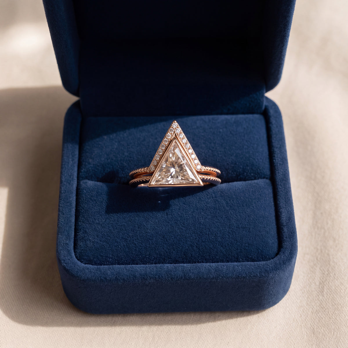 Rose gold ring set, a trillion-cut diamond and a chevron diamond band
