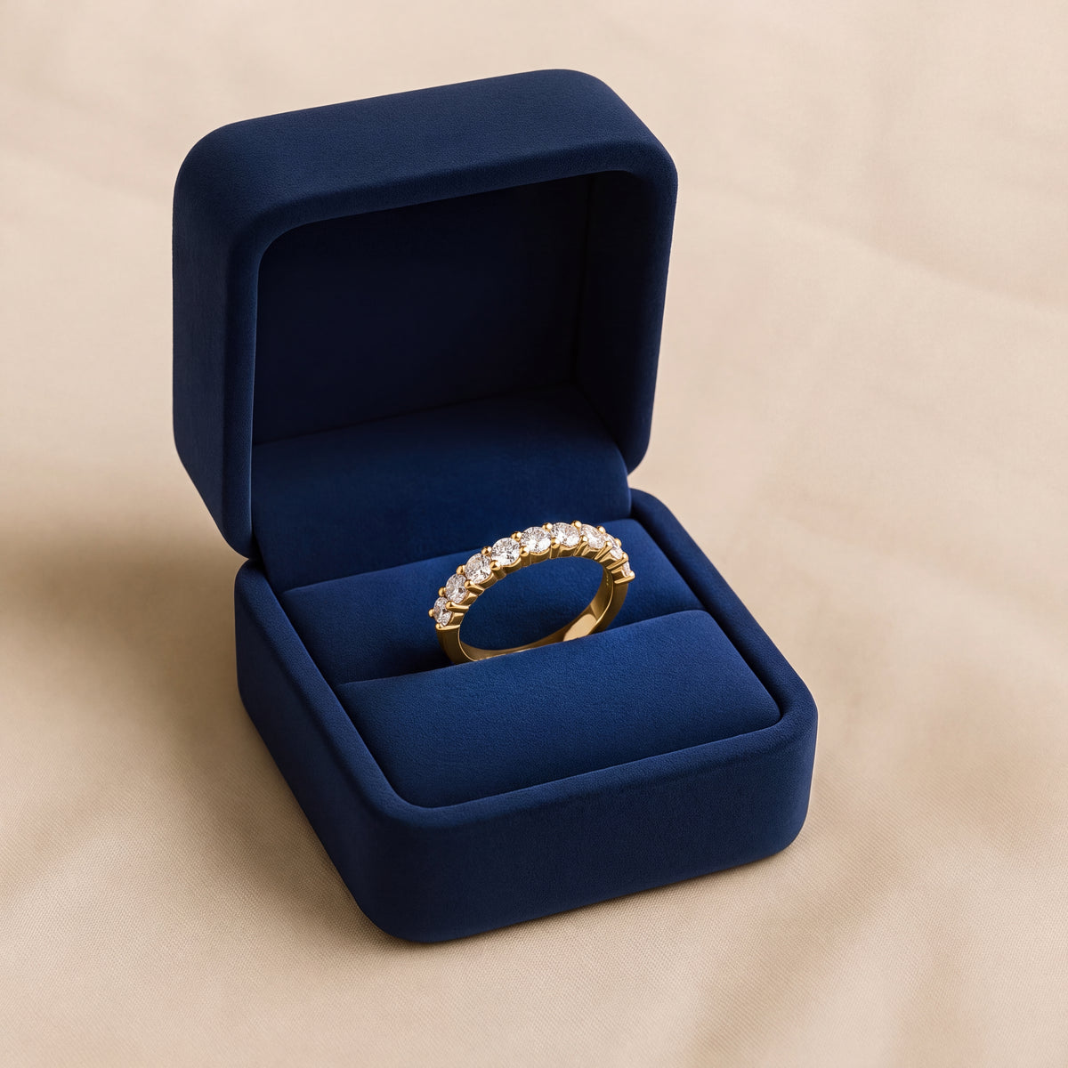 Yellow gold band with round diamonds in shared prongs
