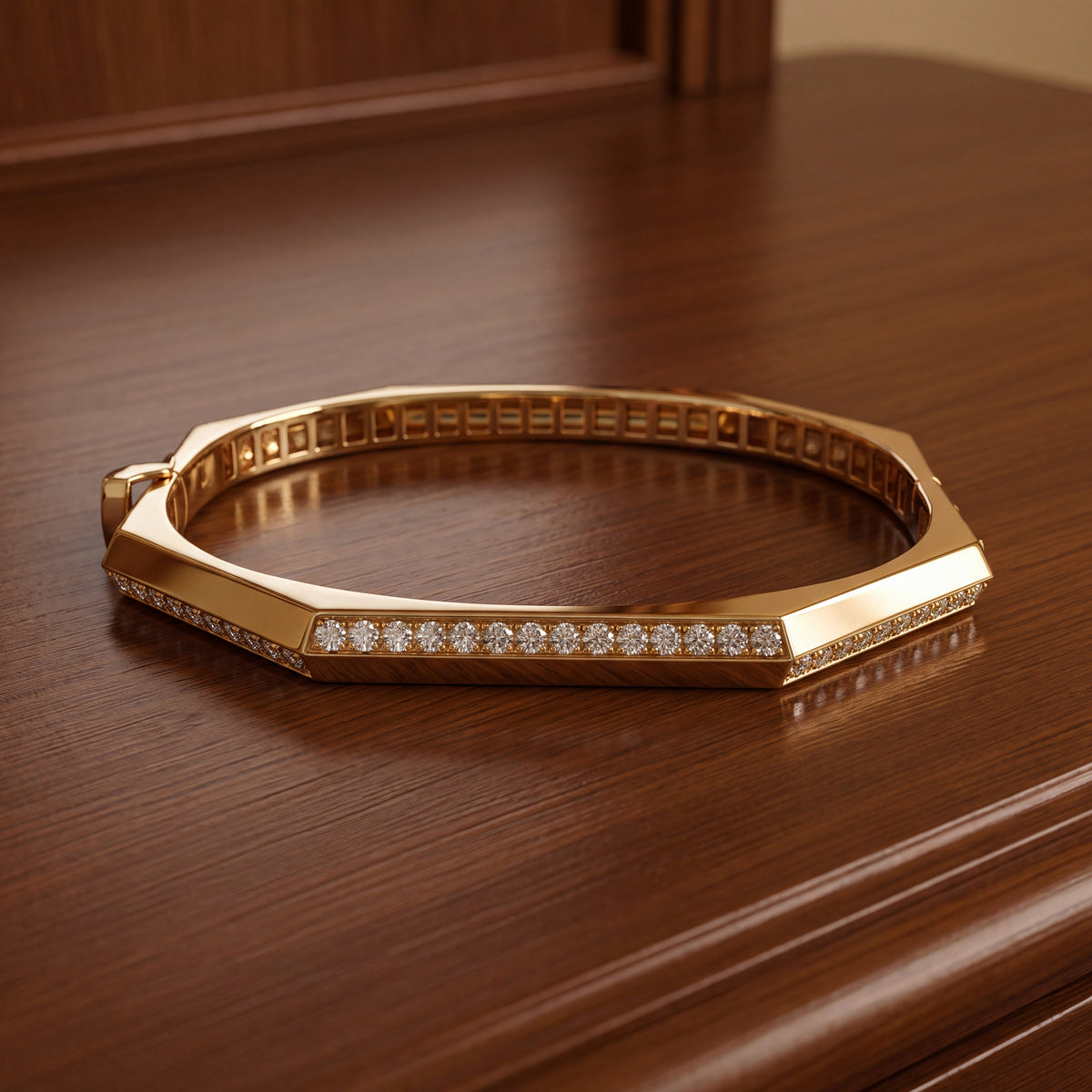 Faceted geometric yellow gold bangle with a line of diamonds
