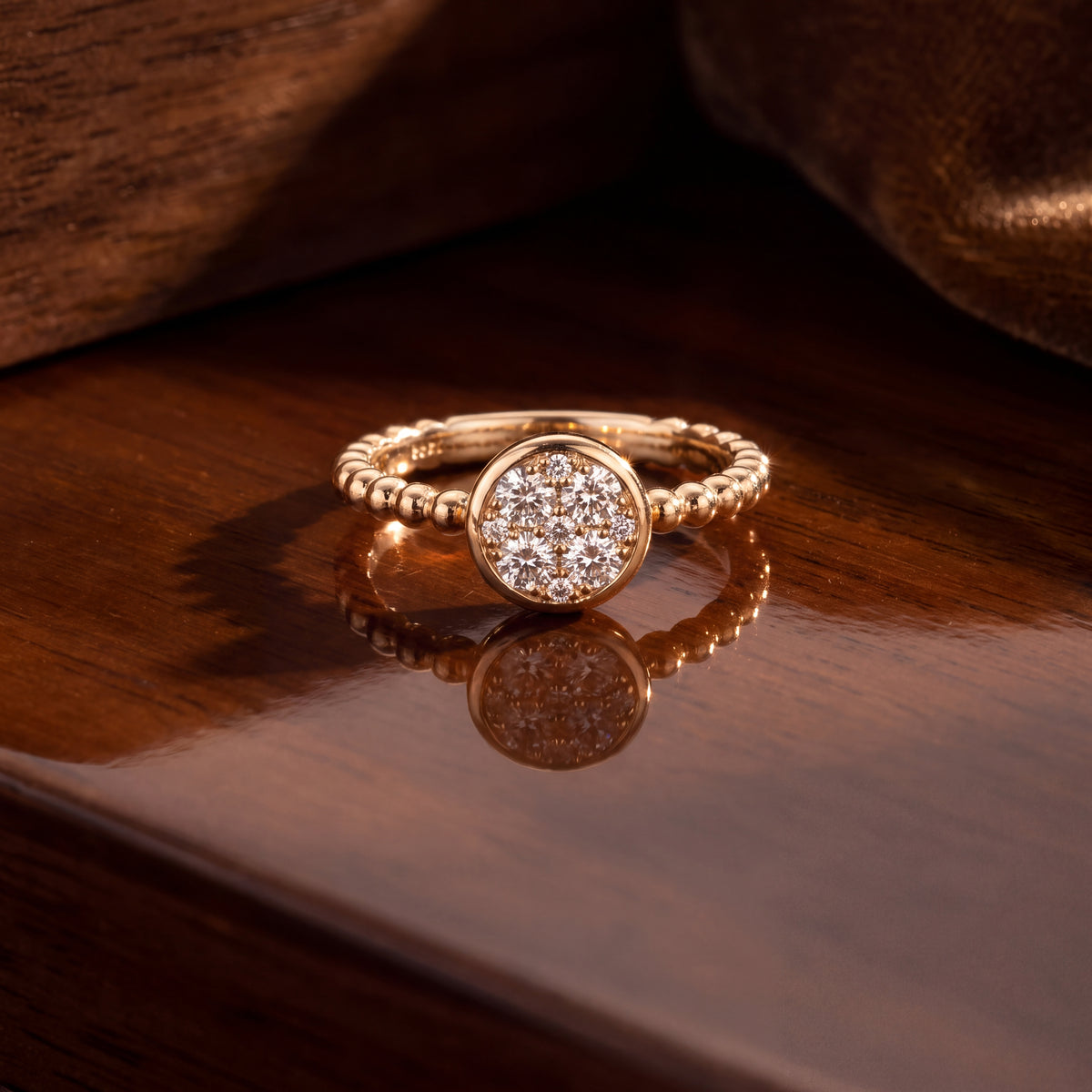 Round diamond cluster on a beaded yellow gold band