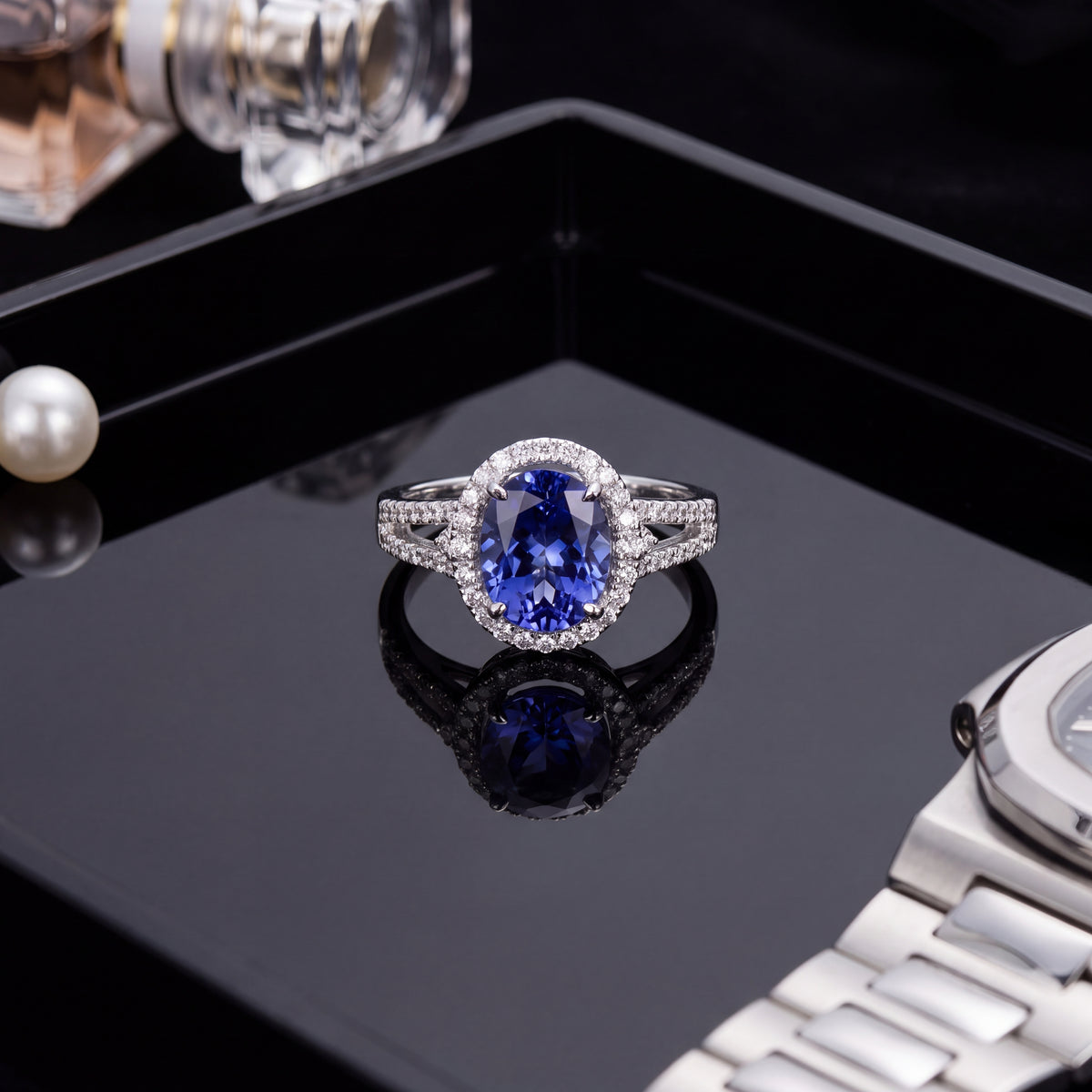 Oval tanzanite in a diamond halo on a tapering split shank