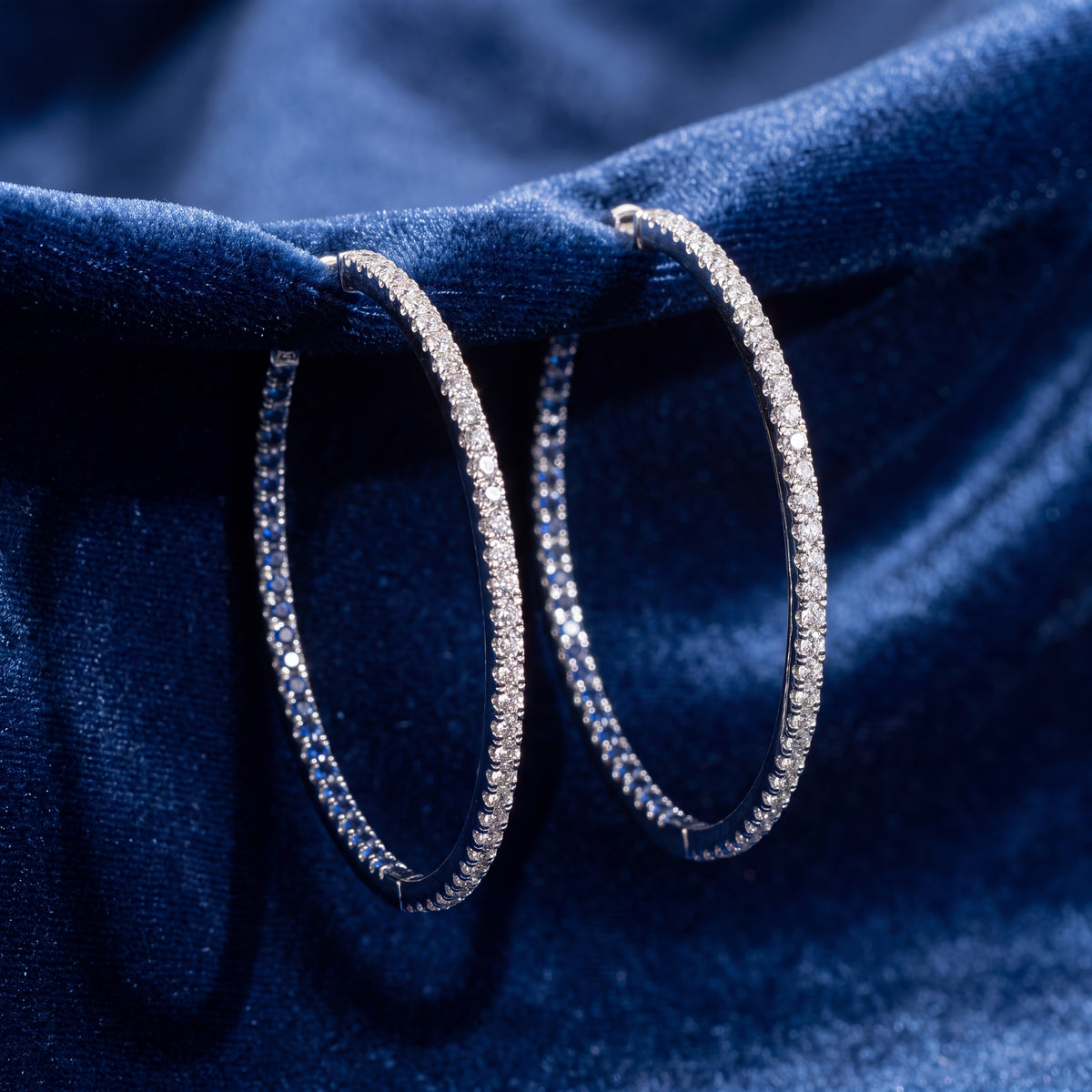 Large white gold hoop earrings of sapphires and diamonds