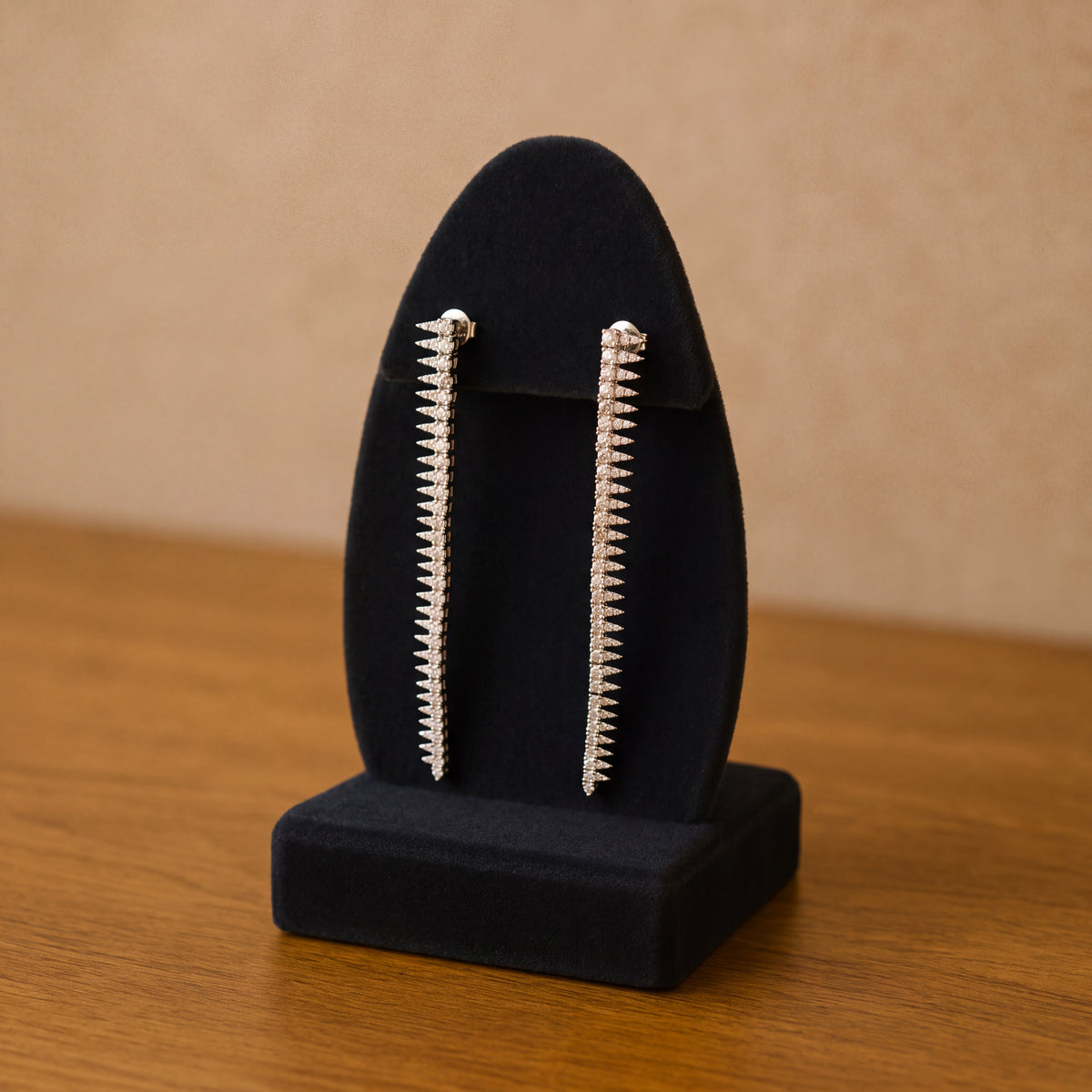 Long white gold earrings of diamond-set spikes
