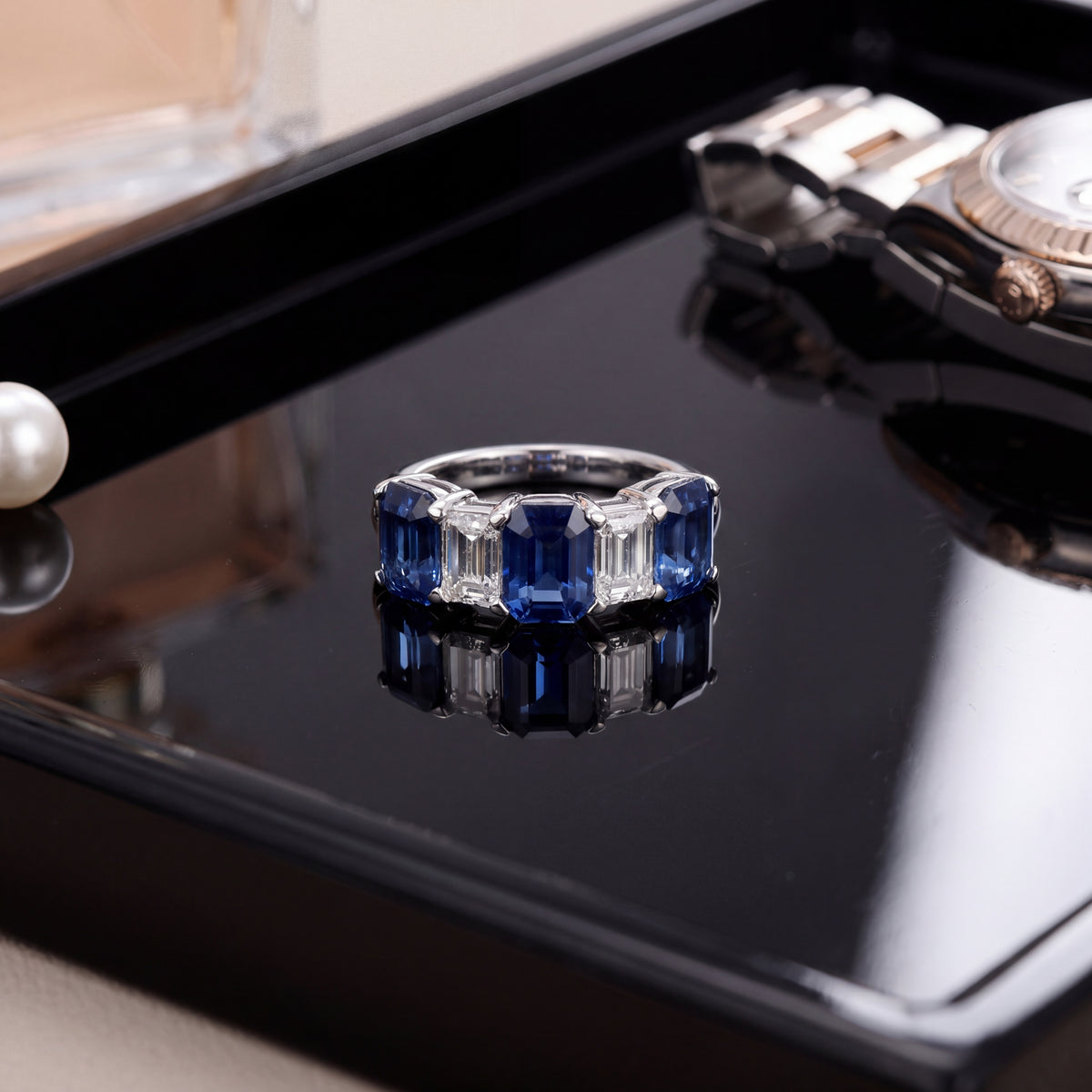 Five-stone ring of emerald-cut blue sapphires and diamonds