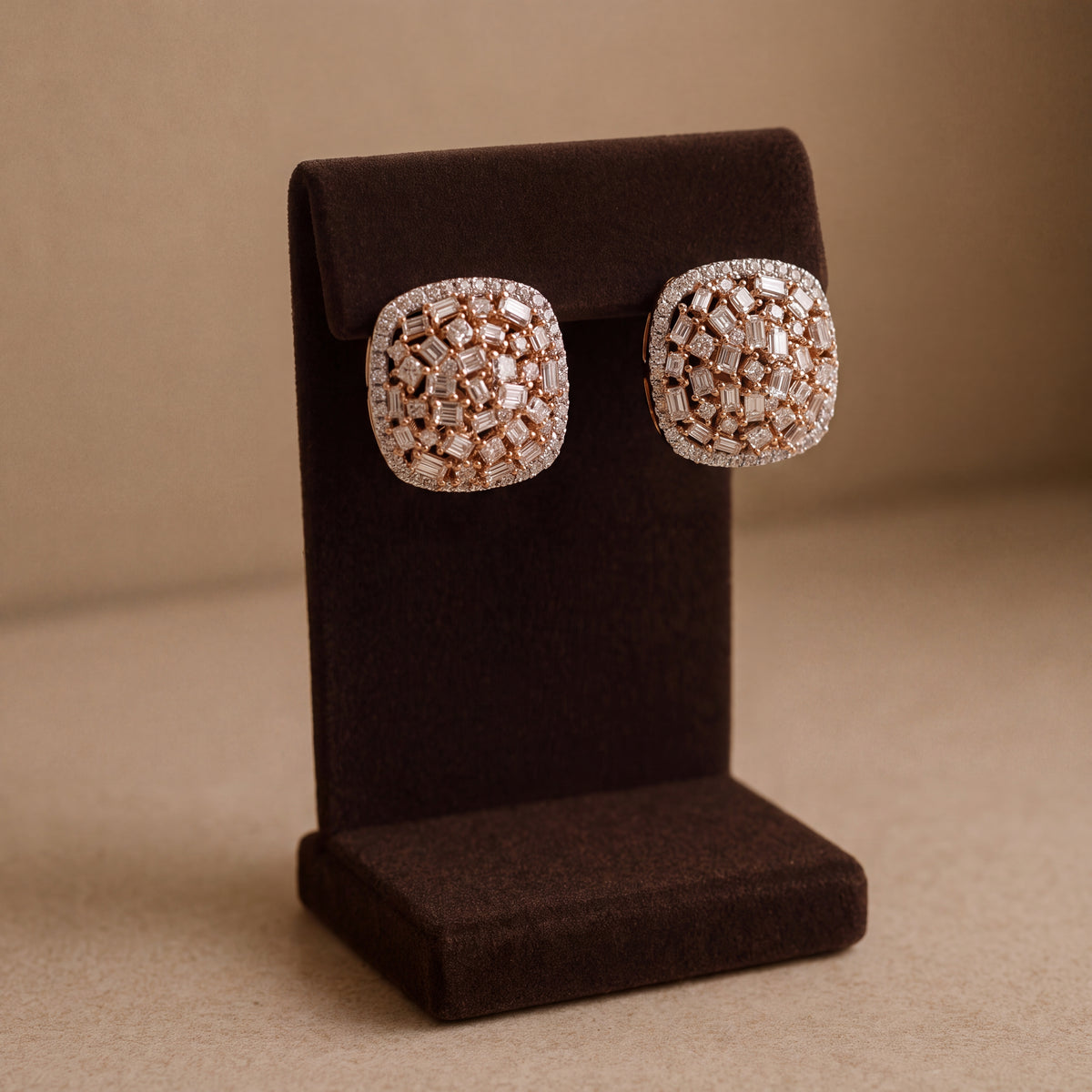 Cushion-shaped stud earrings of baguette and round diamonds in halos