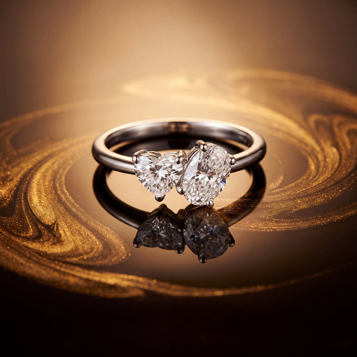 Two-stone ring with a heart-shaped diamond beside a larger elongated diamond on a white gold band