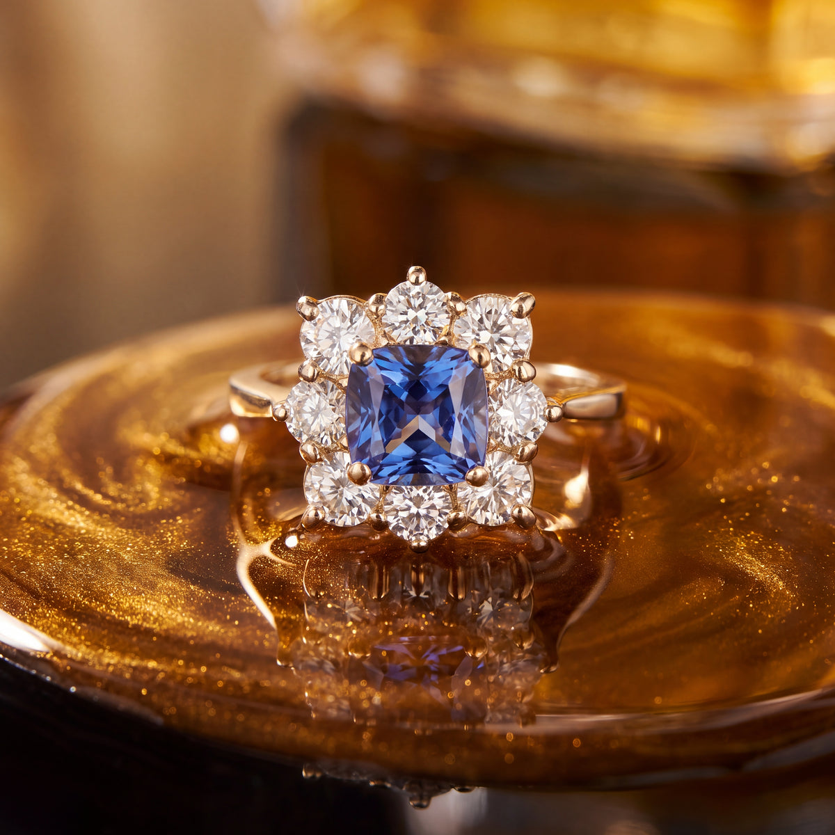 Cushion-cut tanzanite in a floral diamond halo on a yellow gold band