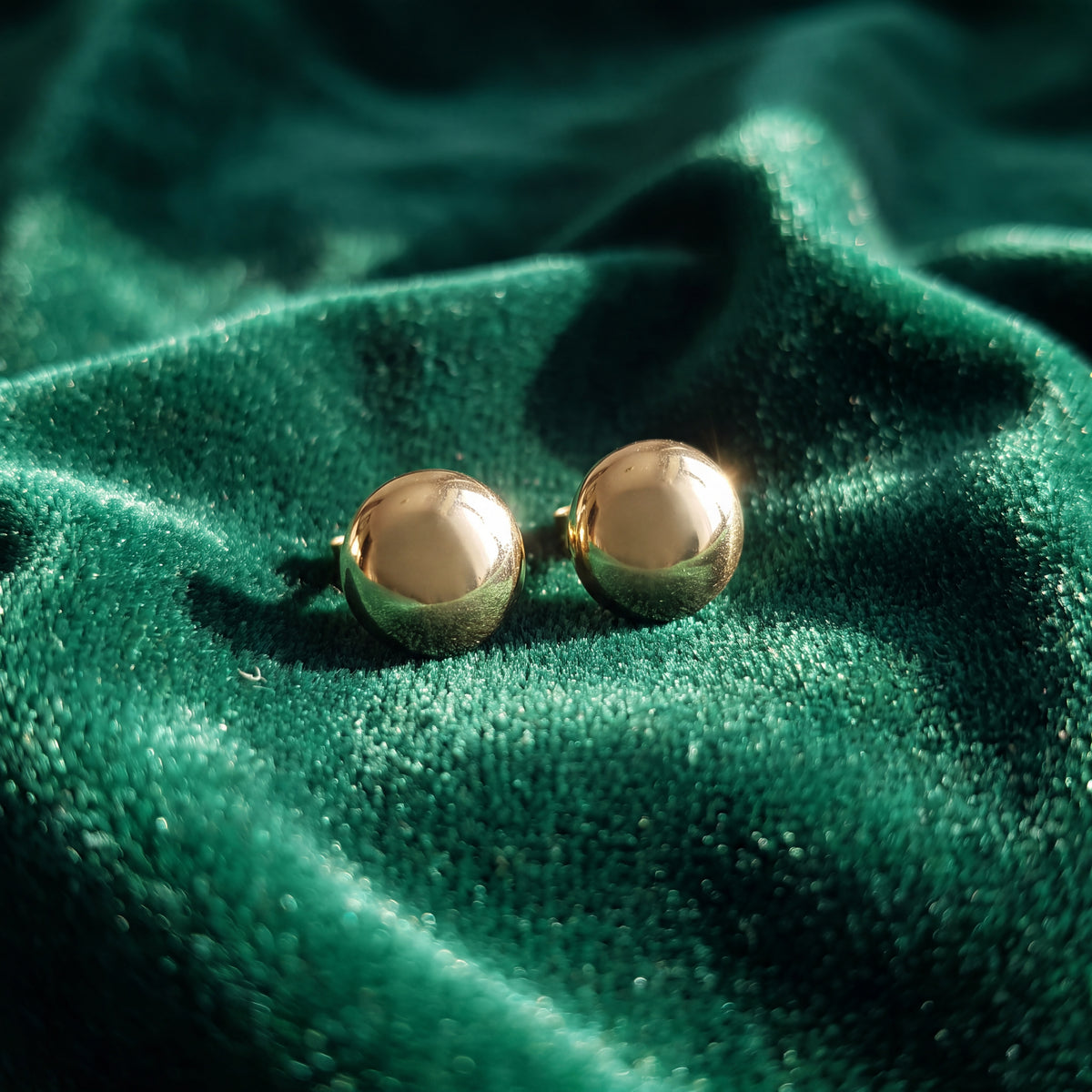 Pair of polished yellow gold dome stud earrings