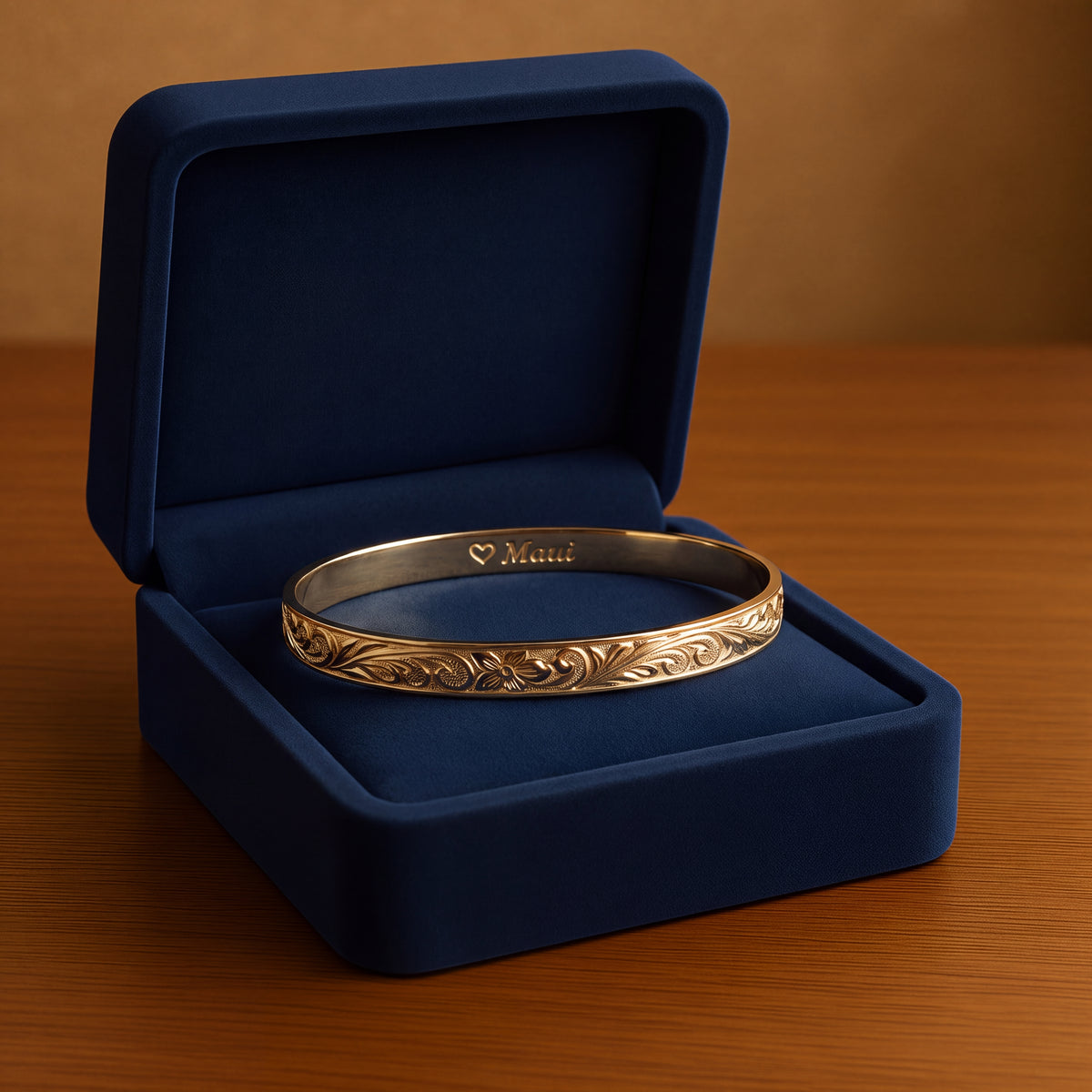 Engraved floral yellow gold bangle with a Maui inscription