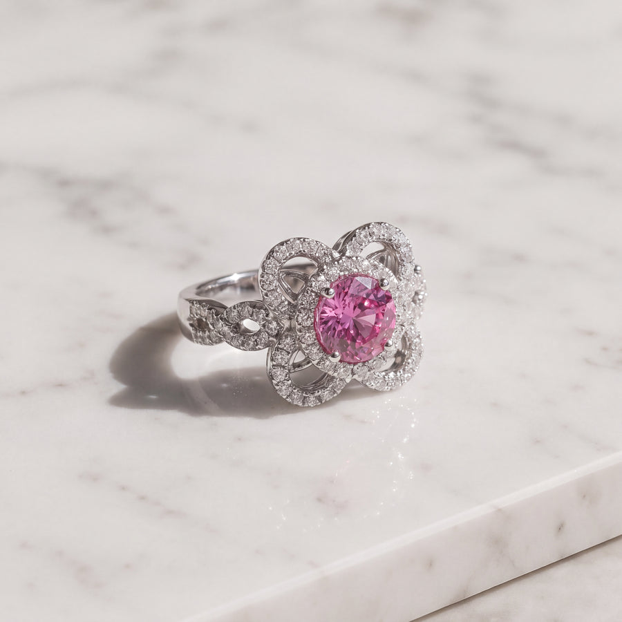 Pink sapphire cocktail ring with an openwork floral pave diamond halo in 14K white gold