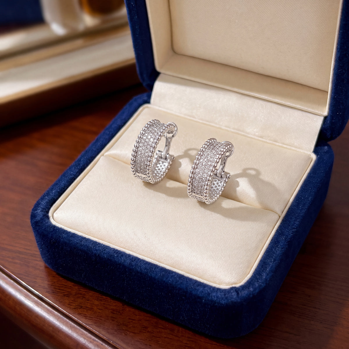 White gold hoop earrings set with diamonds