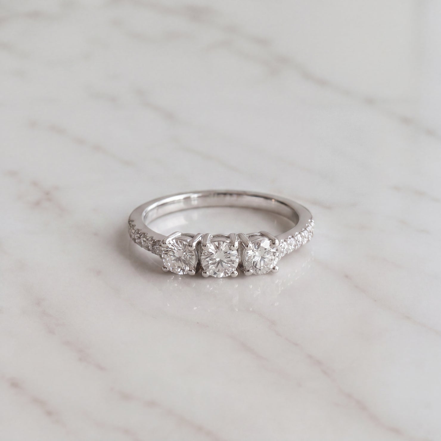 White Gold Three-Stone Diamond Ring with Pavé Band