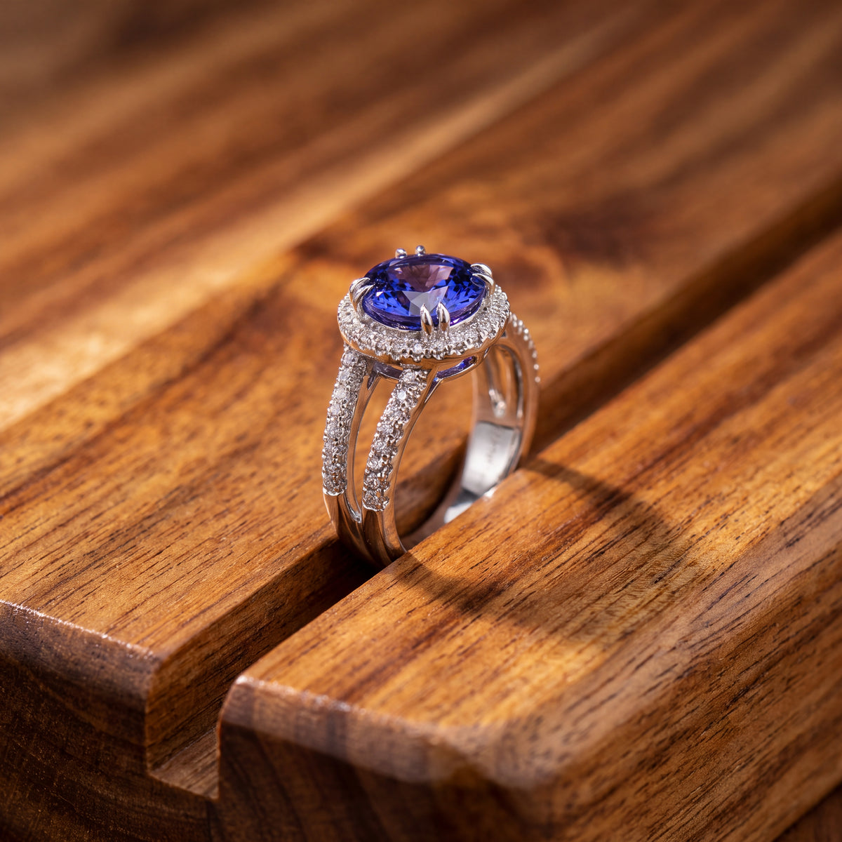 Round tanzanite in a pavé halo on a white gold split-shank band
