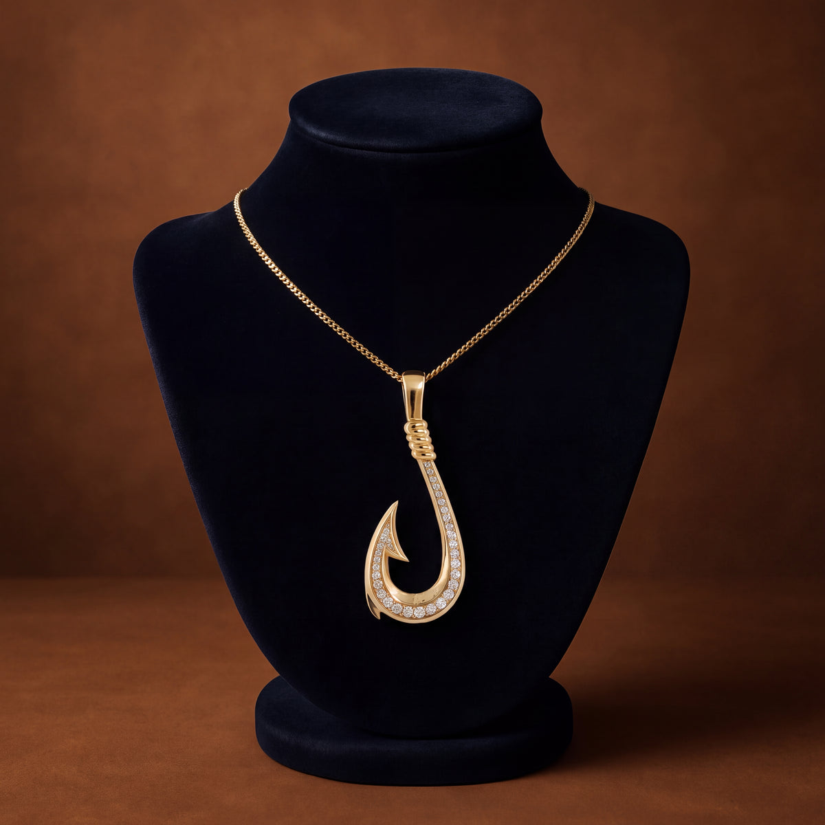 Yellow gold fish hook pendant with a row of diamonds