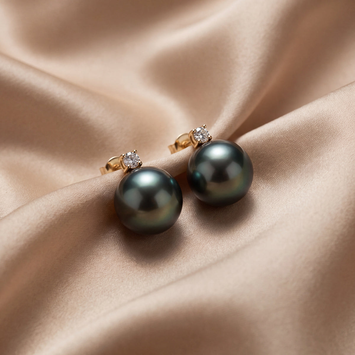 Grey pearl stud earrings each topped with a small diamond
