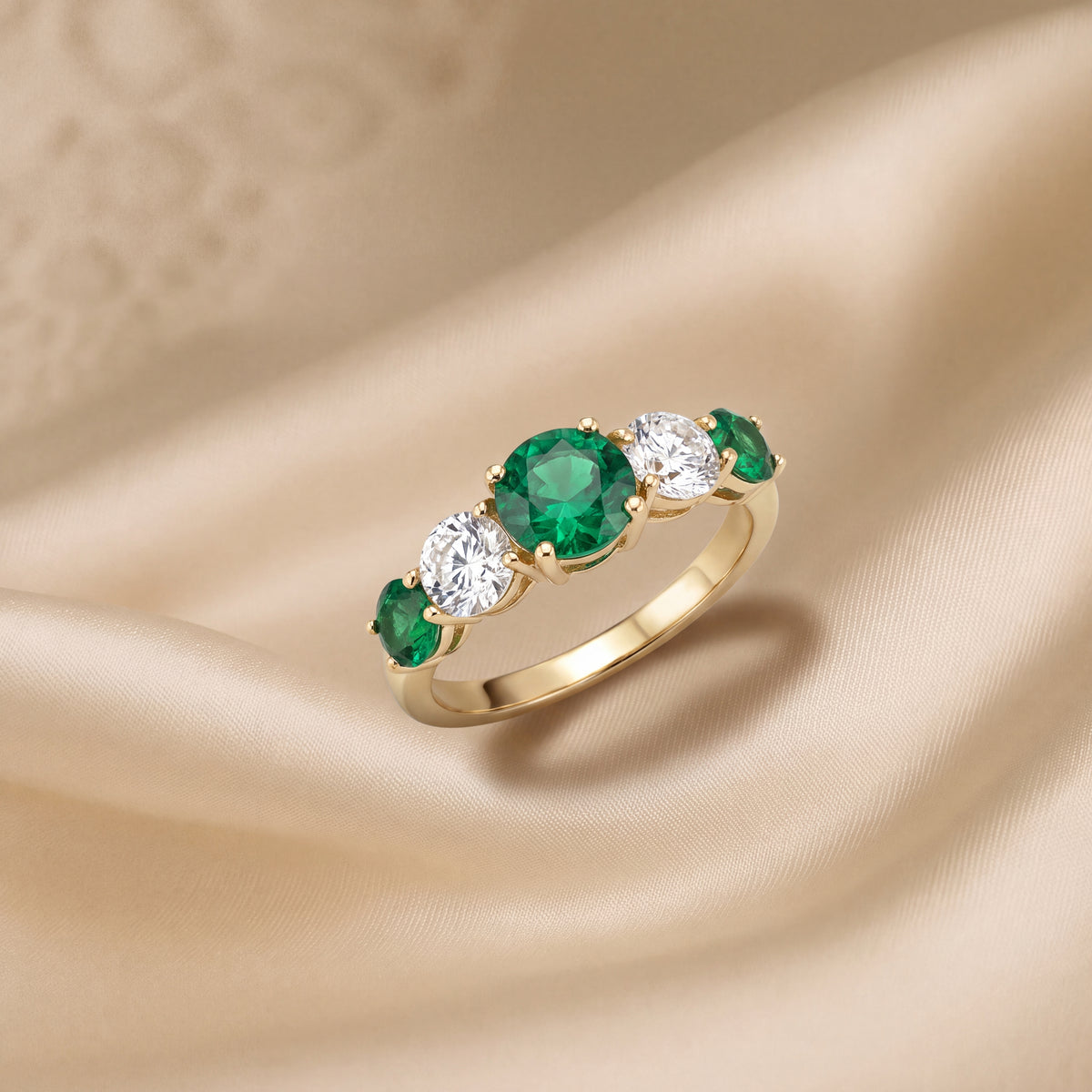 Five-stone yellow gold ring of round emeralds alternating with clear round stones
