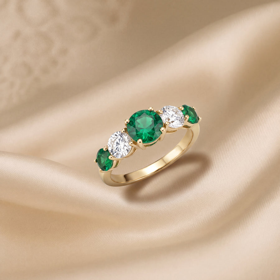 Five-stone yellow gold ring of round emeralds alternating with clear round stones