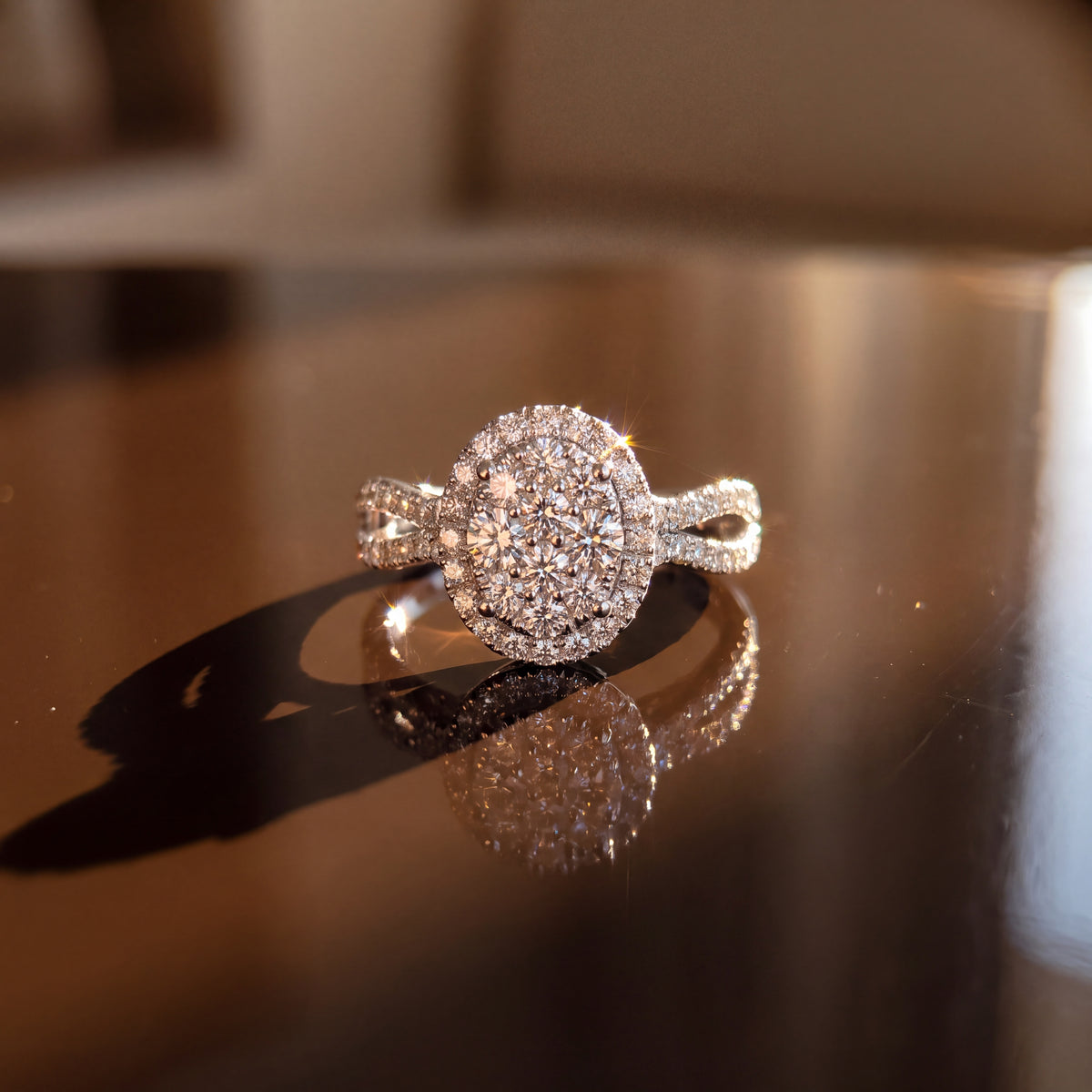 Oval cluster of pavé diamonds in a halo on a split-shank band