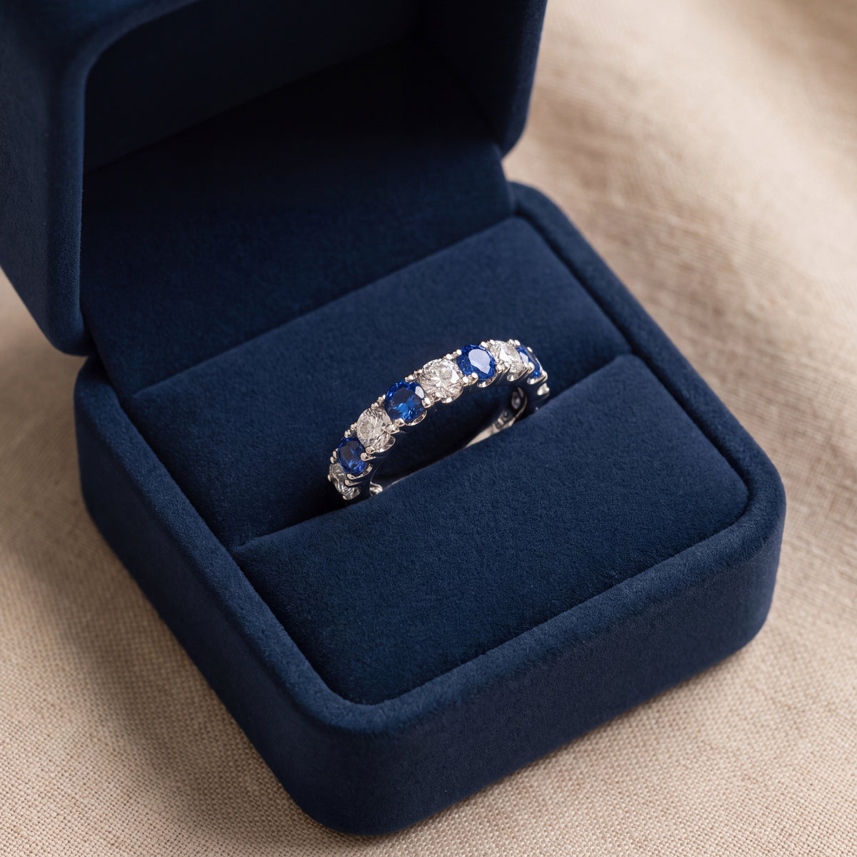 White gold eternity band of blue sapphires and white stones