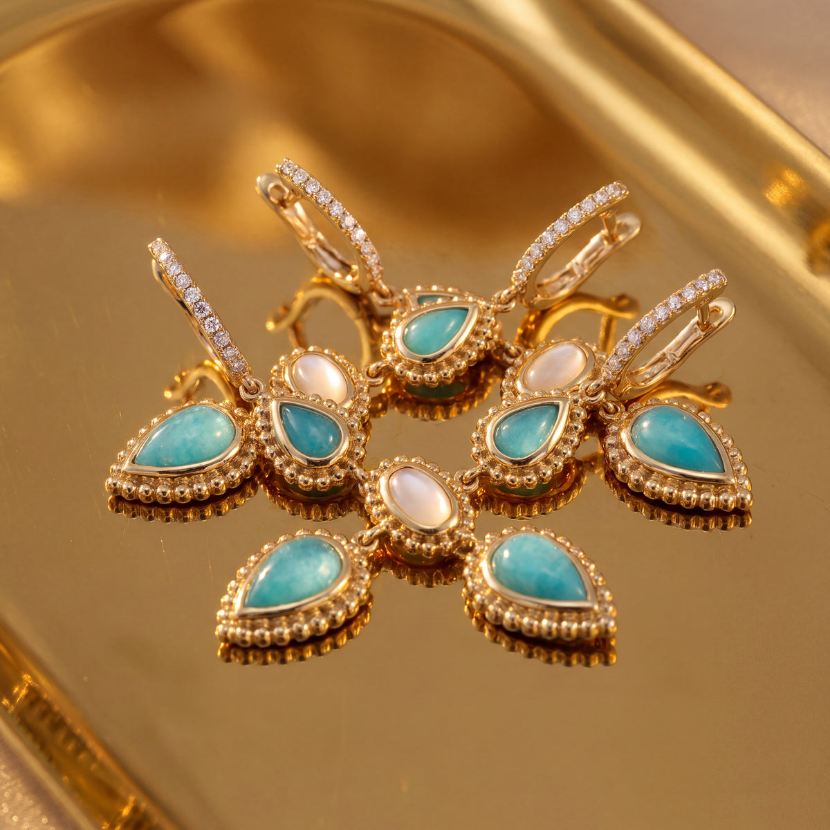 Yellow gold dangle earrings with pear amazonite and oval mother of pearl in beaded bezels on diamond-set hoops