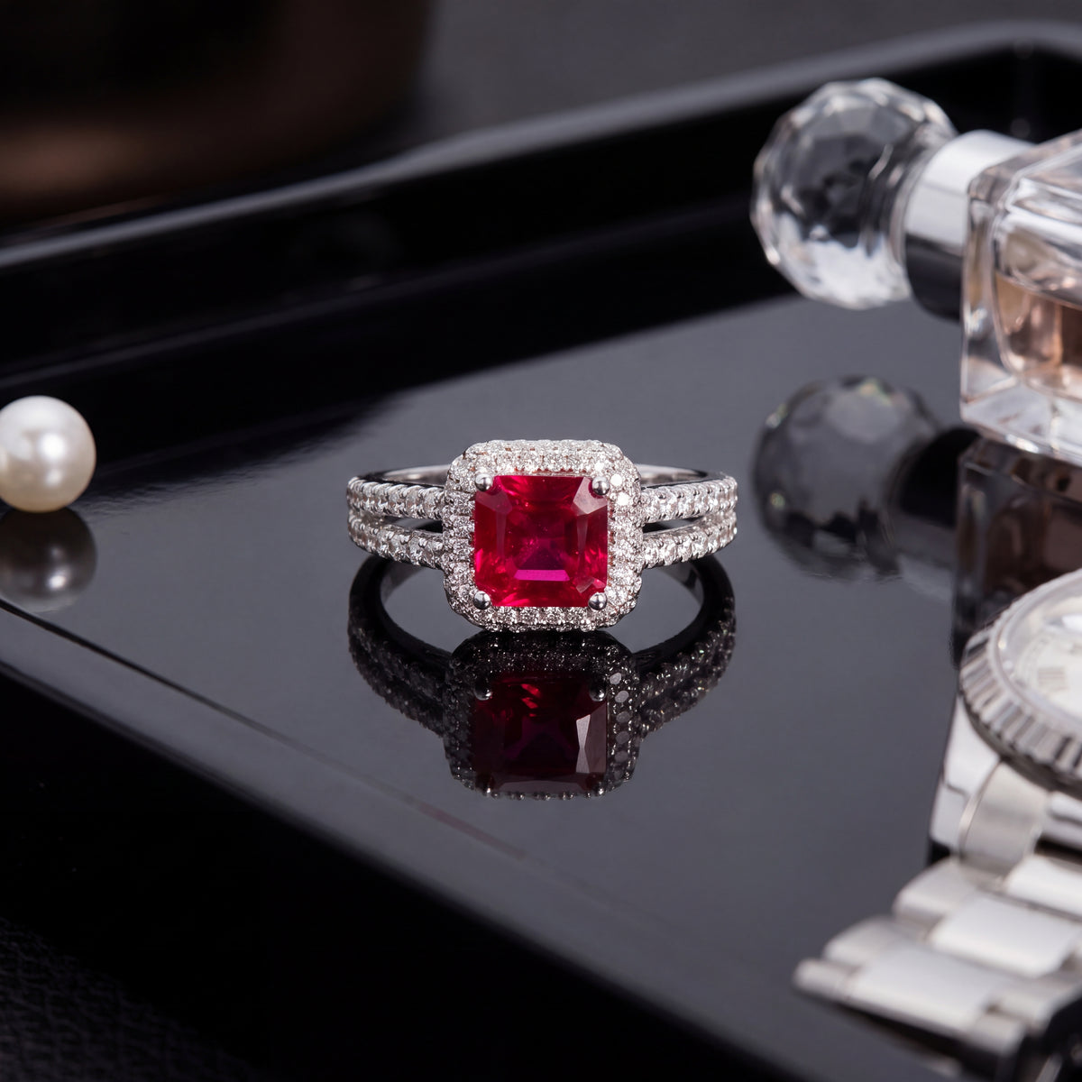Red ruby in a diamond halo on a diamond-lined split shank