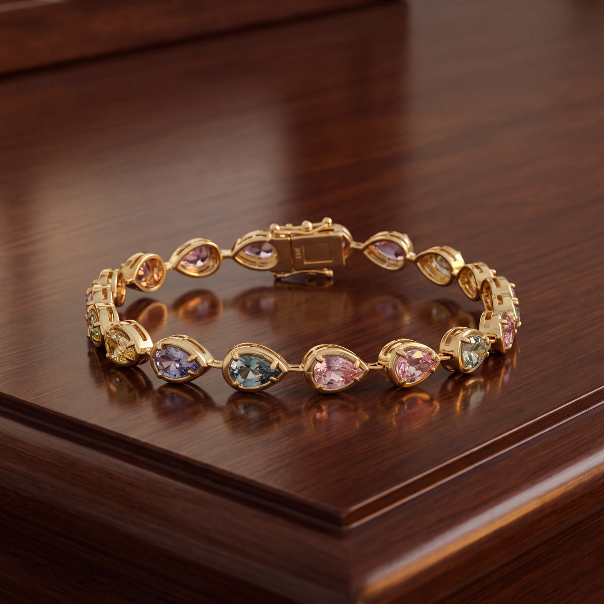 Yellow gold bracelet of pear-shaped pastel sapphires in bezels