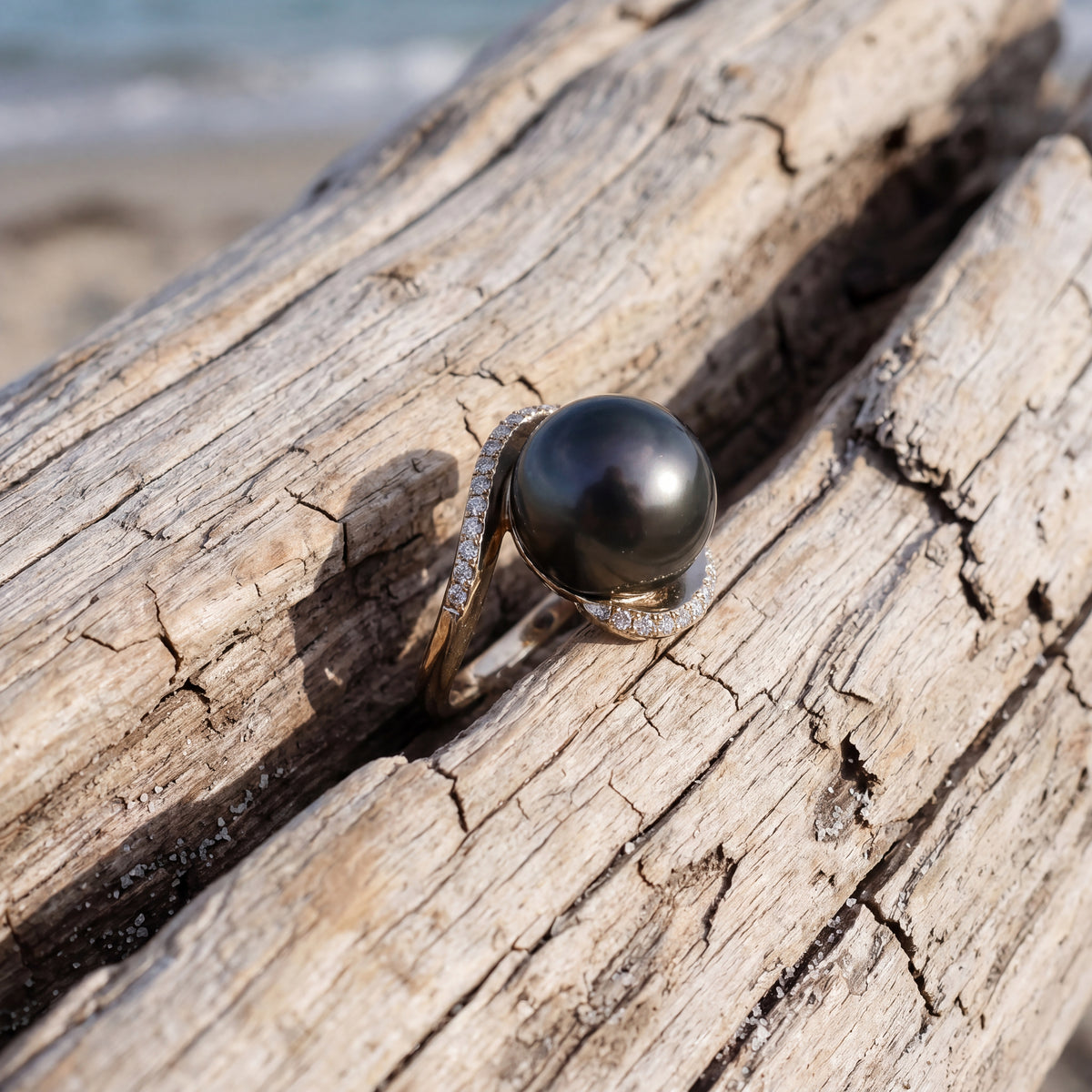 Swirling bypass ring around a black pearl, traced with diamonds