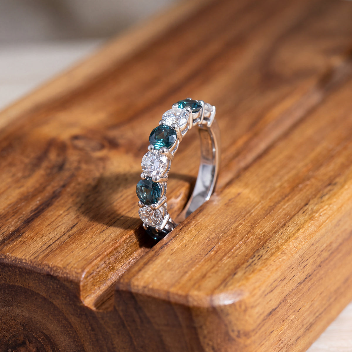 White gold half-eternity band with round alexandrite and round diamonds alternating in prong settings