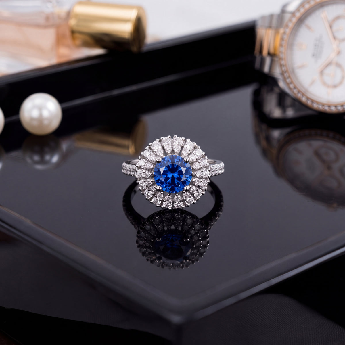 Round tanzanite in a floral diamond halo on a white gold pavé band