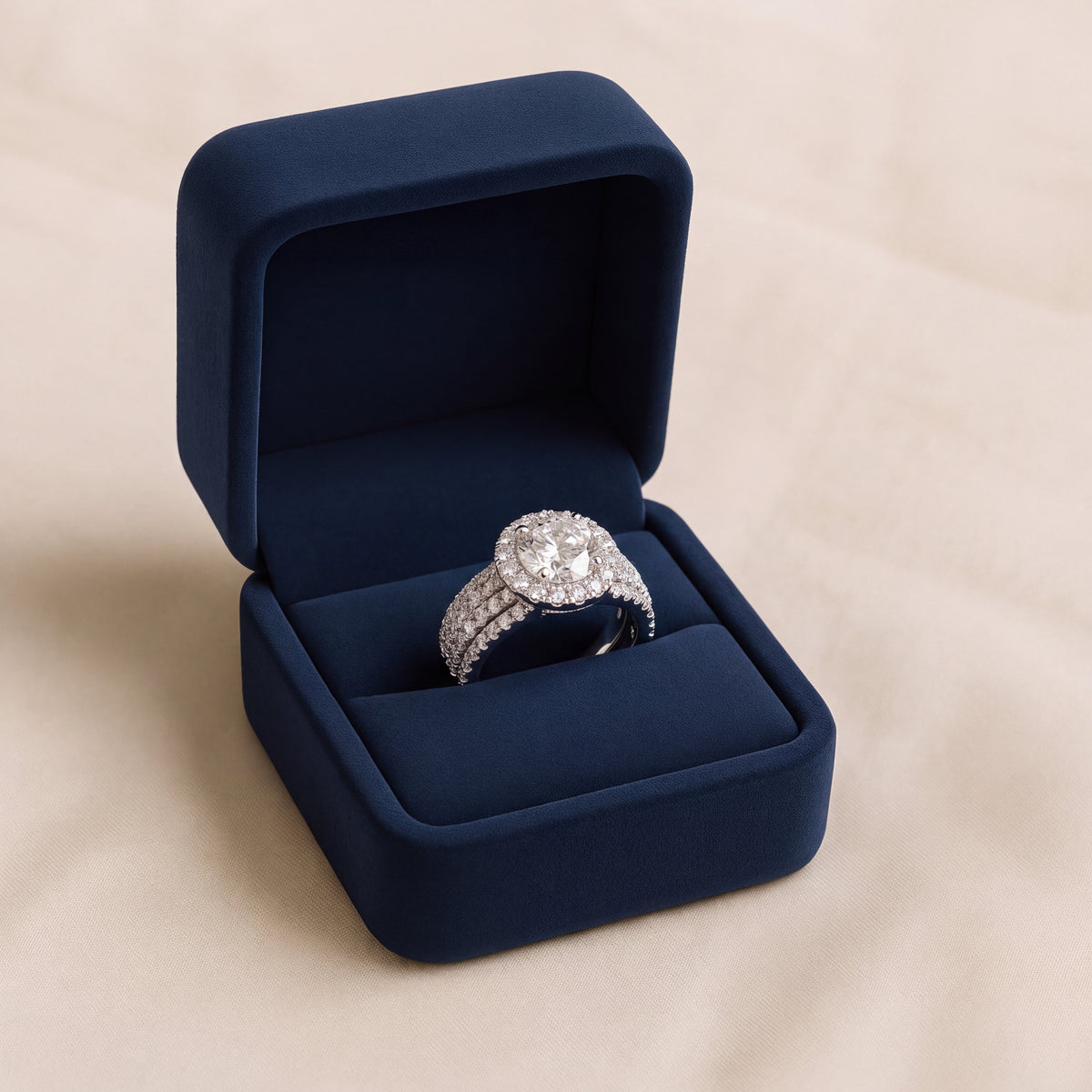 Round diamond halo ring on a wide three-row diamond band