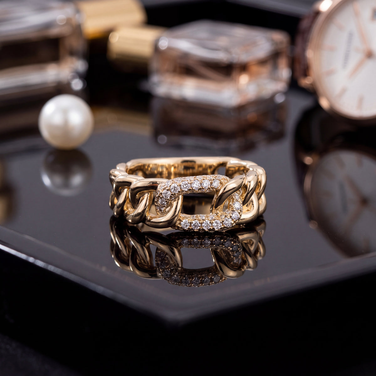 Yellow gold chain link band with one pavé diamond link at the center