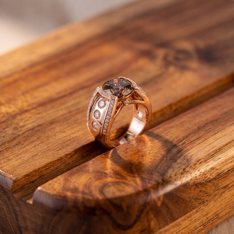 Wide 14K rose gold men's ring with a round fancy brown diamond center, flush-set round diamonds and pavé edges