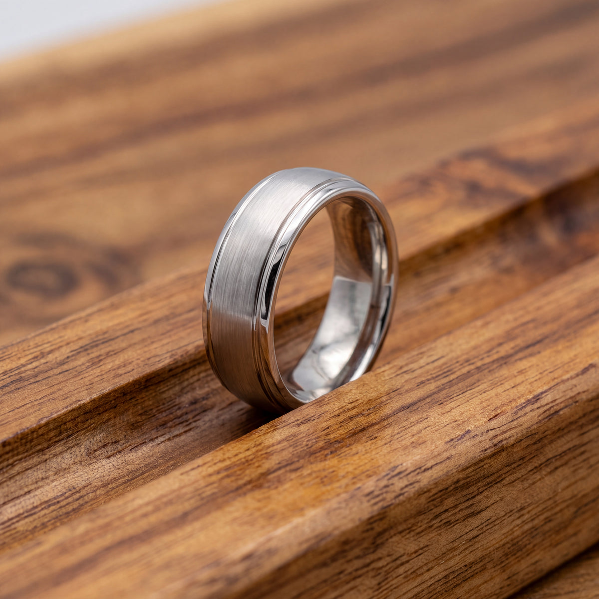 White gold wedding band with a brushed center and stepped edges
