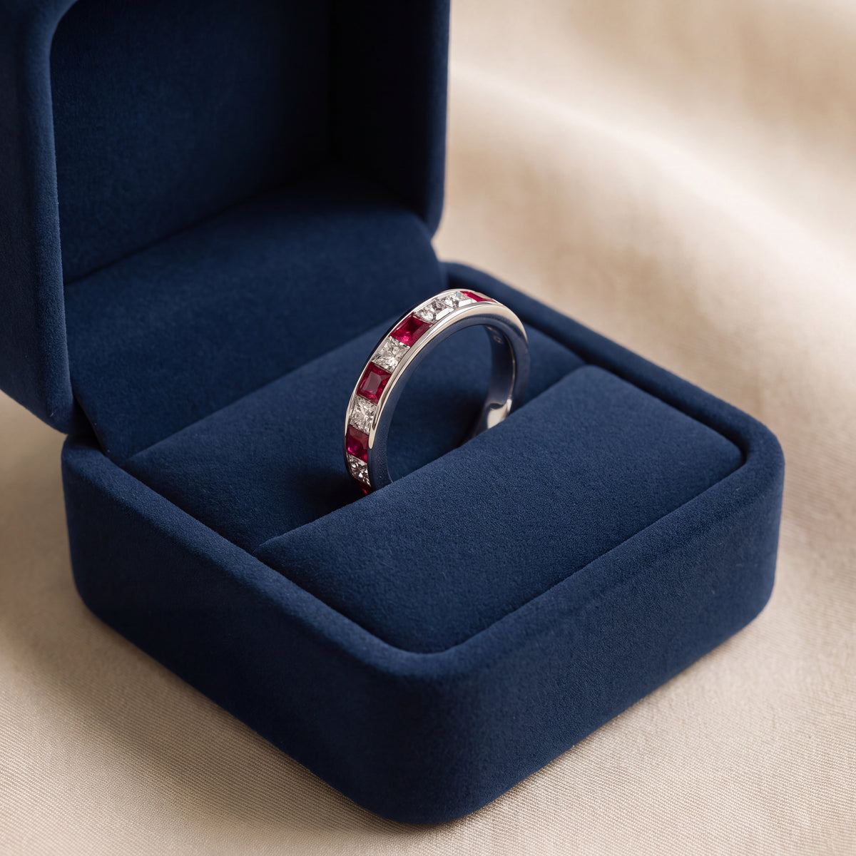 White gold band of square rubies and diamonds in a channel