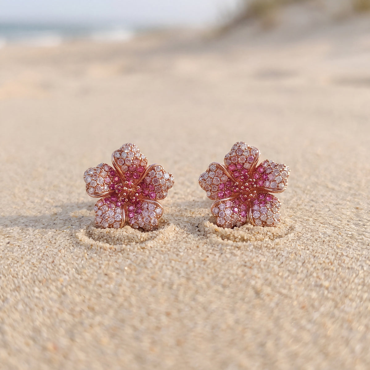 Pair of rose gold flower studs pavé-set with pink sapphires