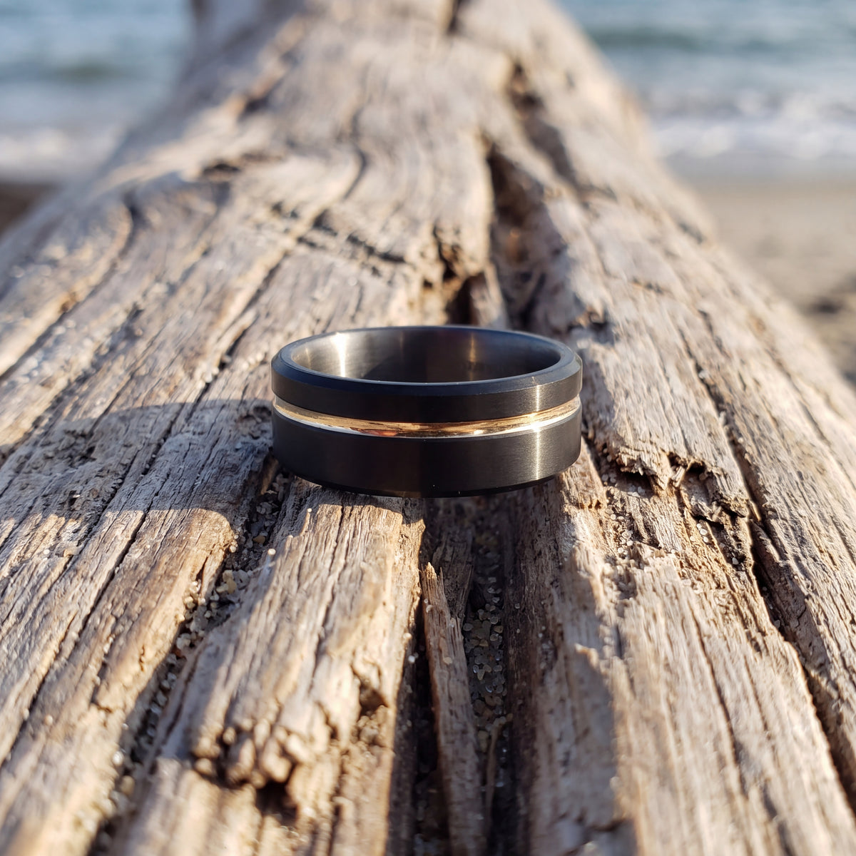 Matte black tantalum band with a thin yellow gold inlay