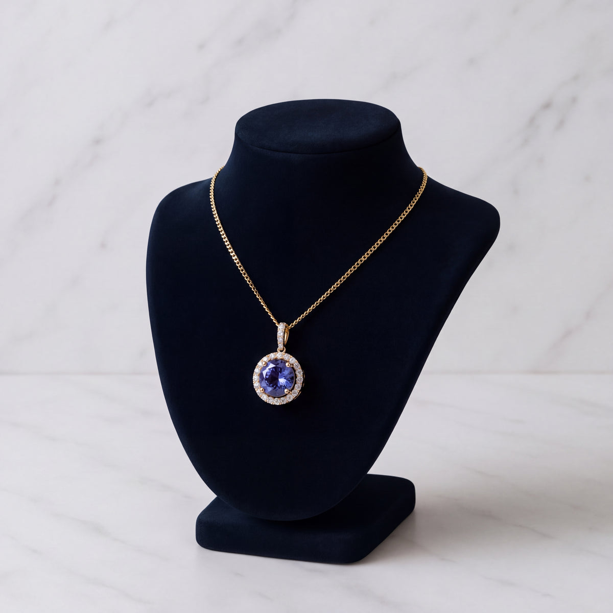 Round tanzanite pendant in a diamond halo on a yellow gold chain