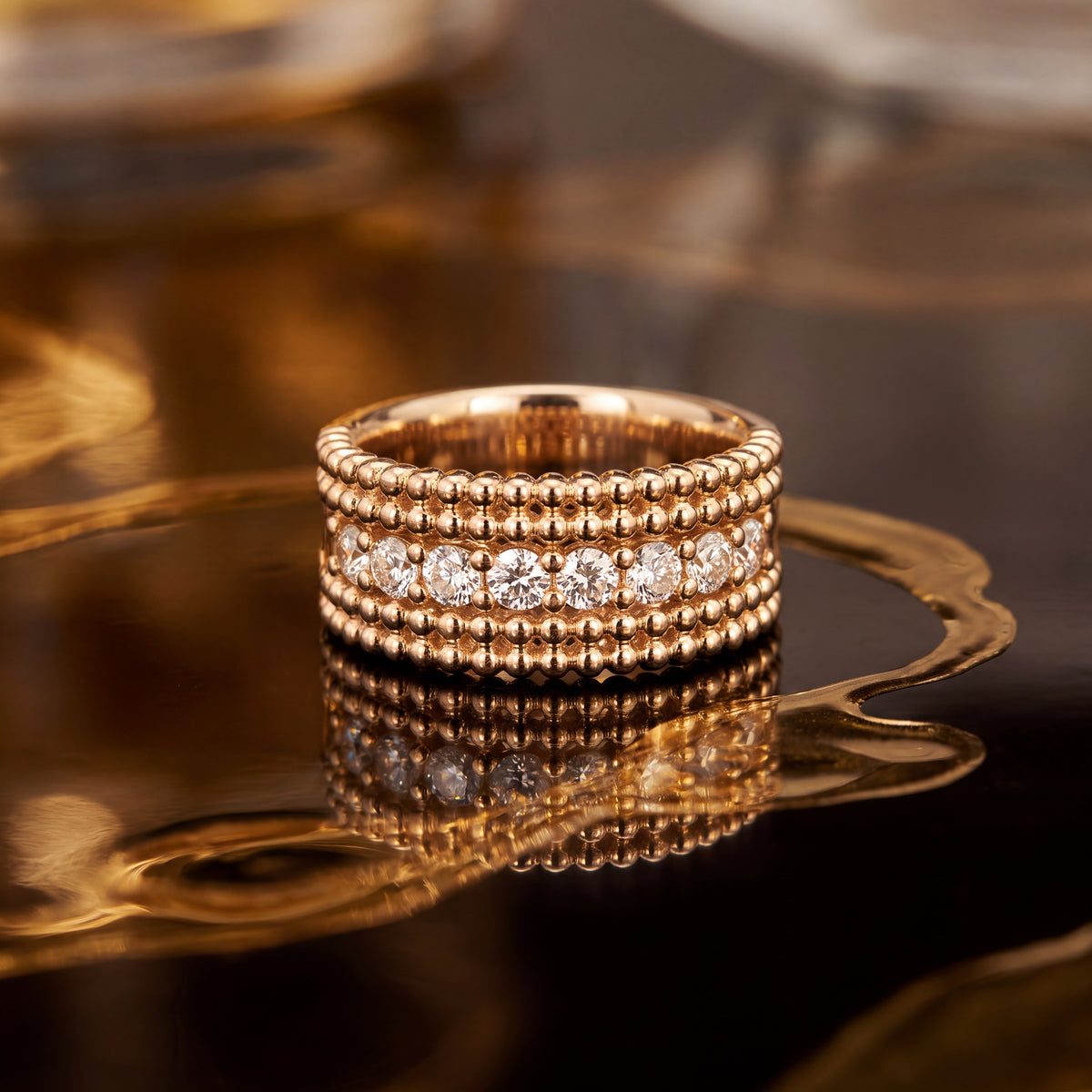 Yellow gold band with a center row of diamonds between beaded rows