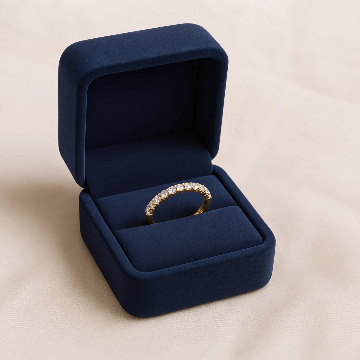 Slender yellow gold eternity band with round diamonds in a shared-prong setting