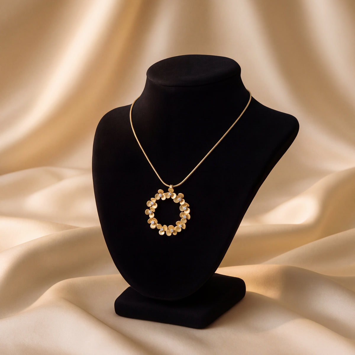 Circular floral wreath pendant necklace in yellow gold with small diamonds set at the center of select blooms