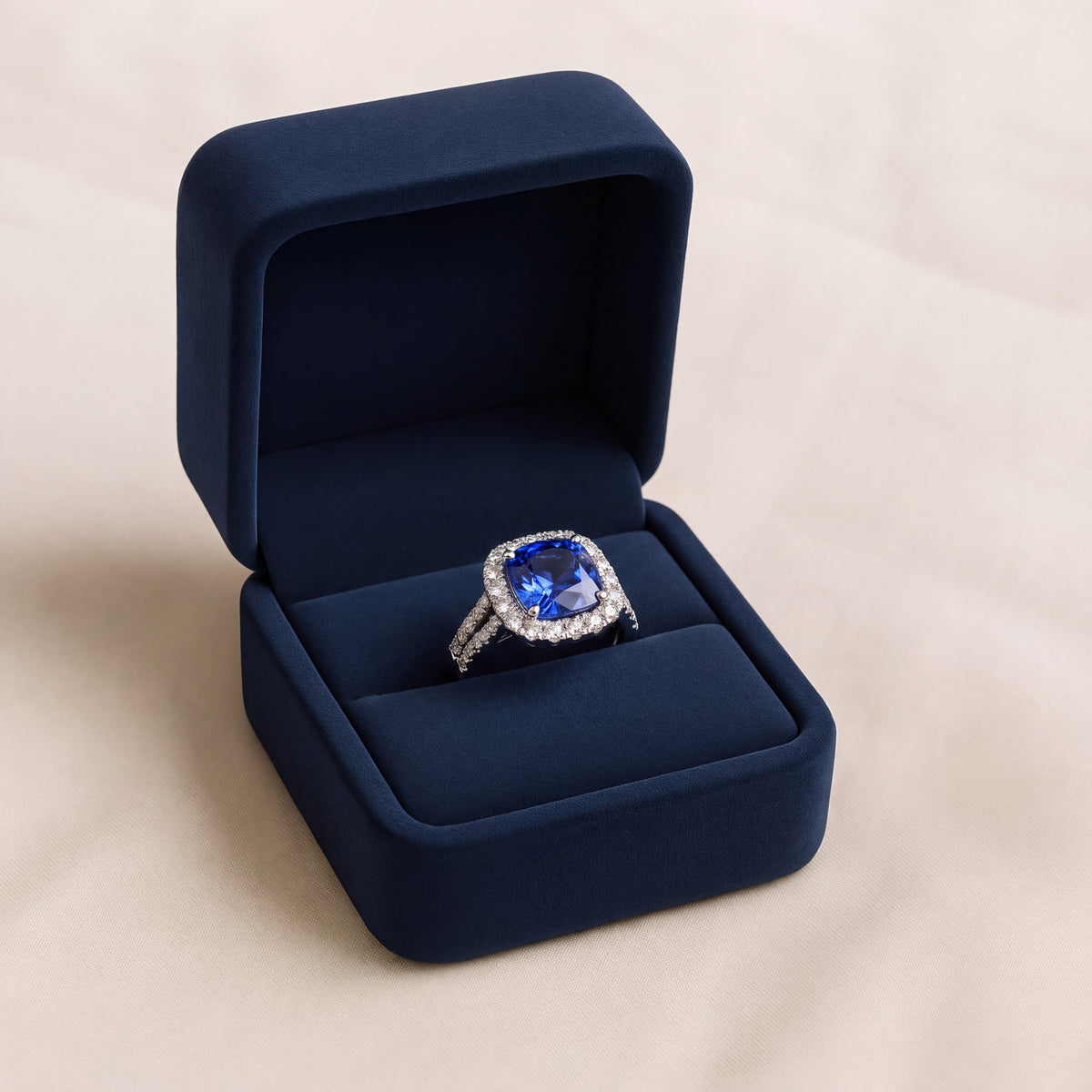 Cushion-cut tanzanite halo ring on a white gold split shank