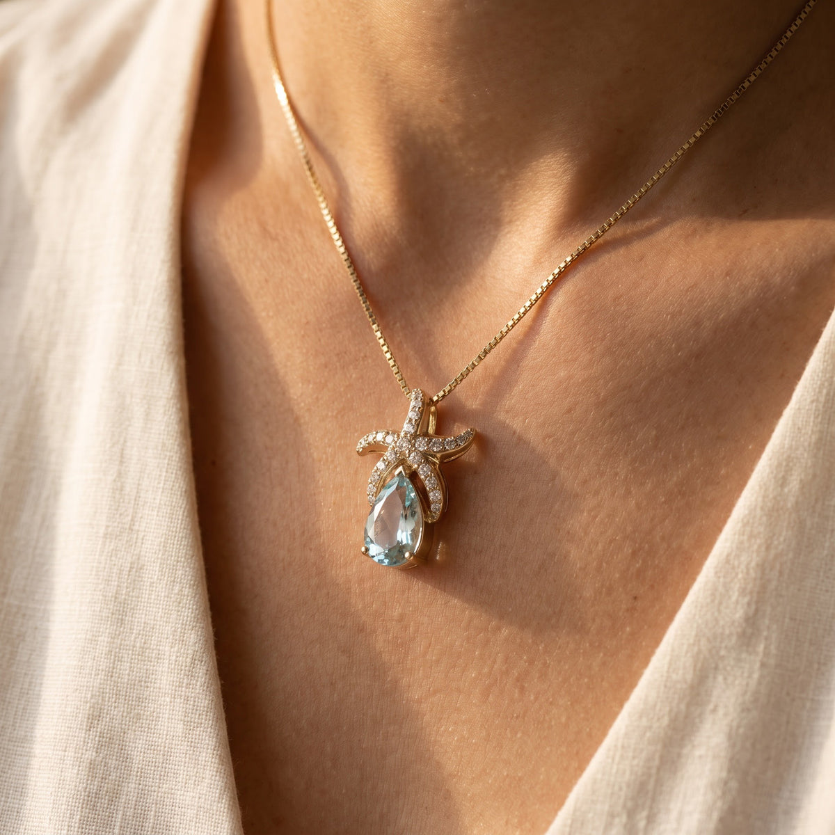 Aquamarine Starfish Pendant Necklace in Yellow Gold, worn