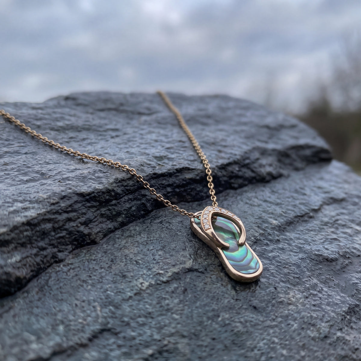 Yellow gold flip-flop charm with an iridescent inlay on a chain