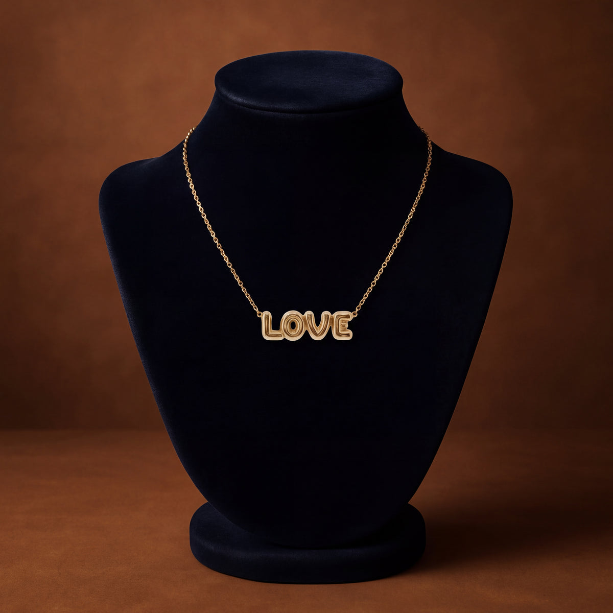 Yellow gold LOVE necklace in rounded balloon letters