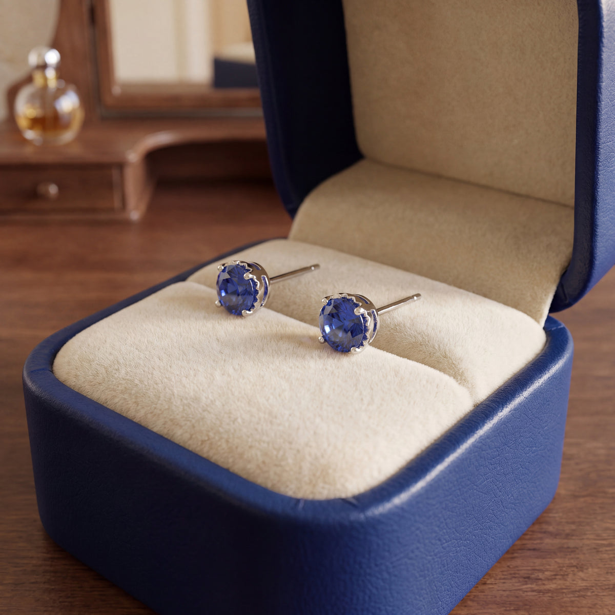 Pair of round blue sapphire stud earrings in white gold