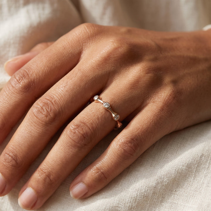 Bezel-Set Diamond Wavy Eternity Ring in Rose Gold, worn