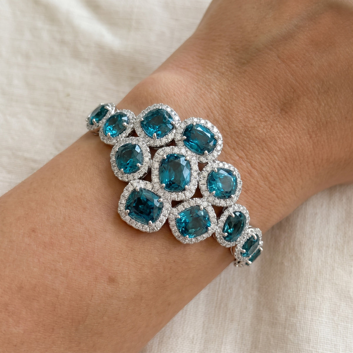 Blue Zircon Halo Cluster Bangle Bracelet in White Gold, worn