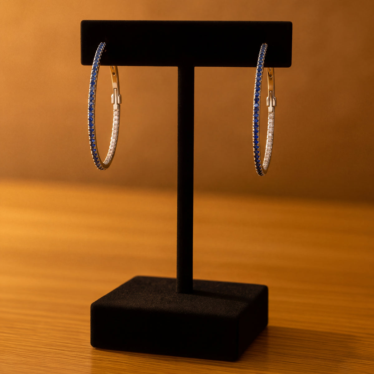 Large white gold hoop earrings set with sapphires